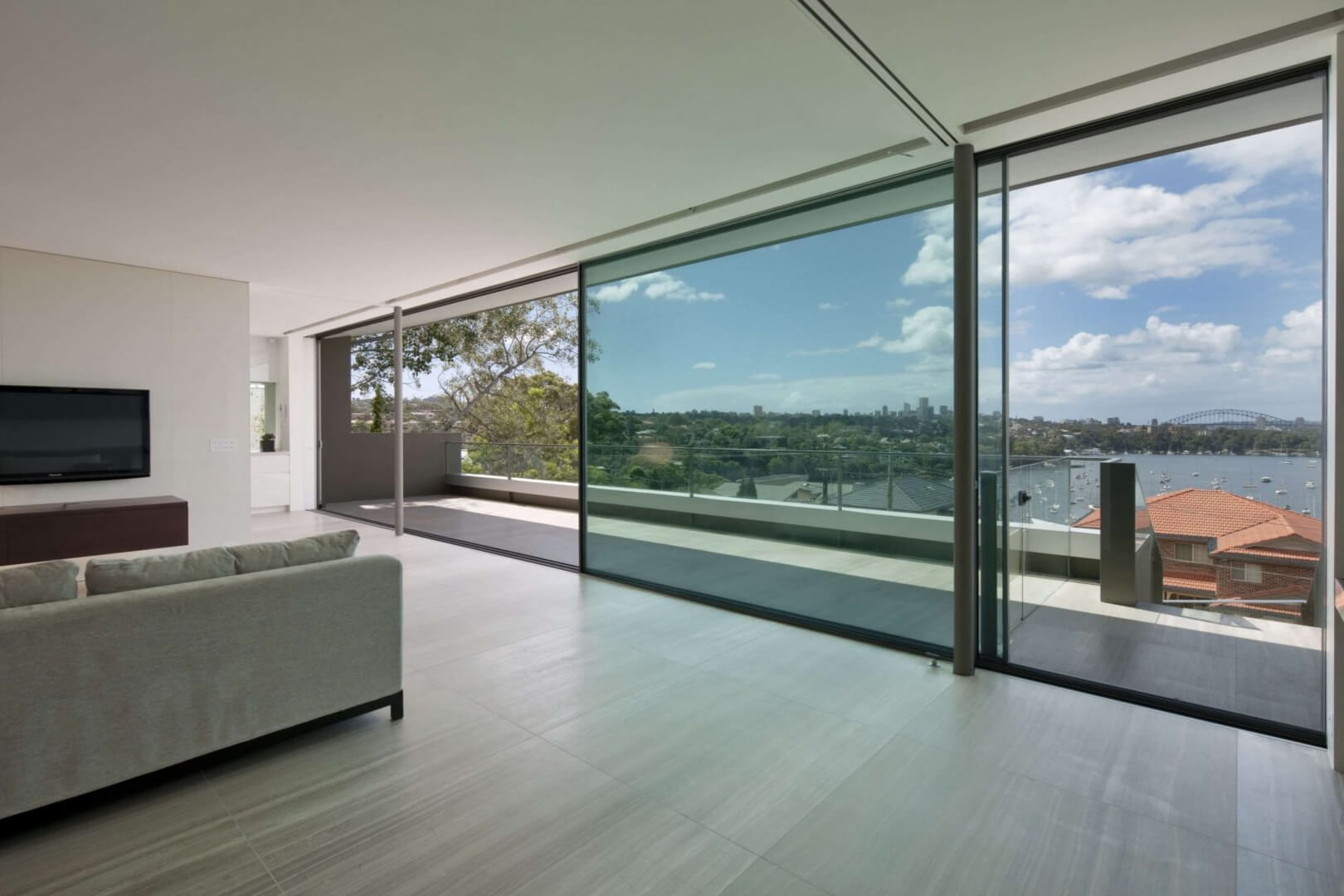 Longueville by Volpatohatz uses Vitrocsa TH+ sliding windows with oversized glazing to frame panoramic views.